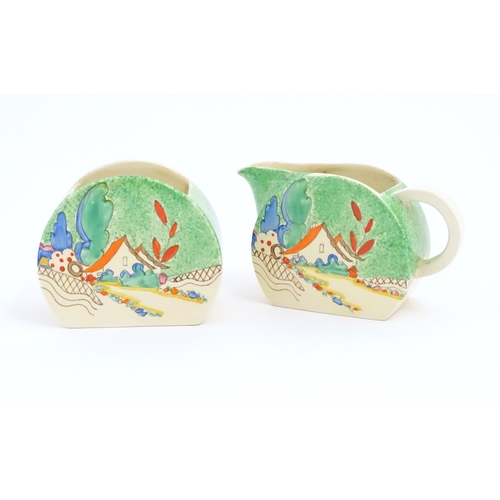 79 - A Clarice Cliff milk jug and sugar bowl decorated in the Chalet pattern. Marked under. Sugar bowl ap... 