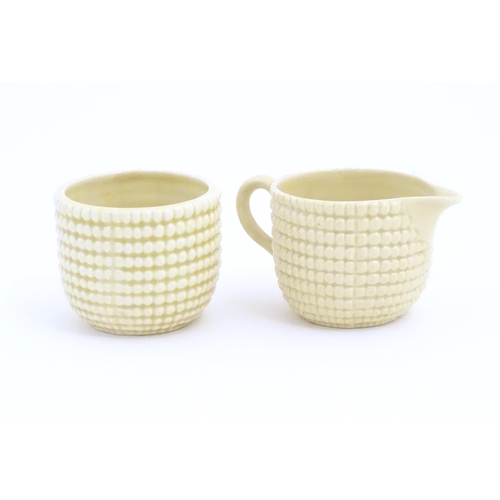 81 - A Clarice Cliff sugar bowl and cream jug in the Corncob pattern. Together with a Royal Staffordshire... 