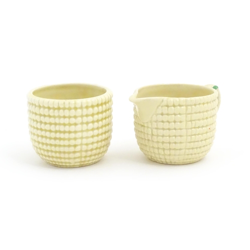 81 - A Clarice Cliff sugar bowl and cream jug in the Corncob pattern. Together with a Royal Staffordshire... 