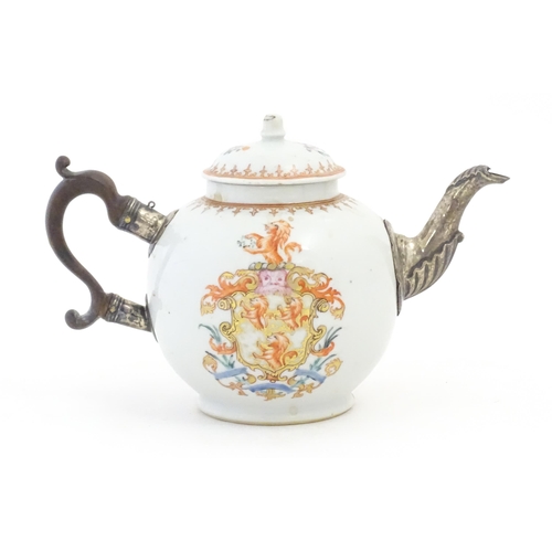 14 - A Chinese Export teapot with silver plate spout, decorated with an armorial depicting rampant lions ... 