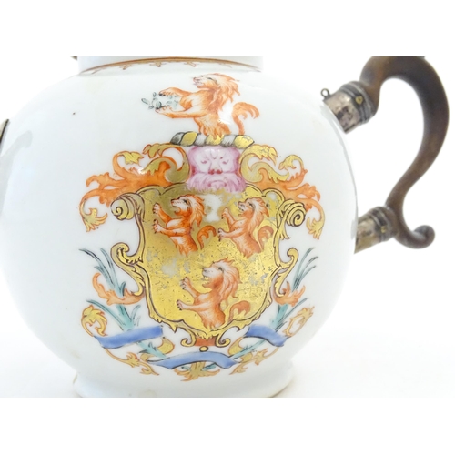 14 - A Chinese Export teapot with silver plate spout, decorated with an armorial depicting rampant lions ... 