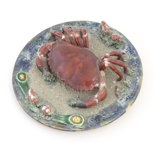 194 - A Palissy style plate with relief crab and shell detail. Approx. 9 3/4