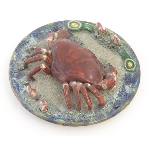 194 - A Palissy style plate with relief crab and shell detail. Approx. 9 3/4