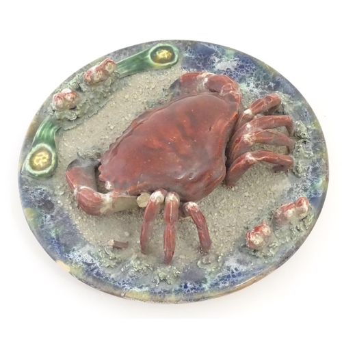 194 - A Palissy style plate with relief crab and shell detail. Approx. 9 3/4