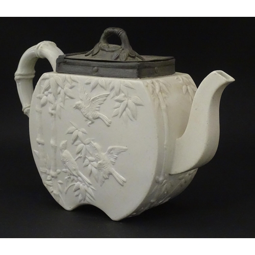 205 - A Victorian Copeland Spode bisque teapot with Aesthetic period decoration depicting birds and bamboo... 