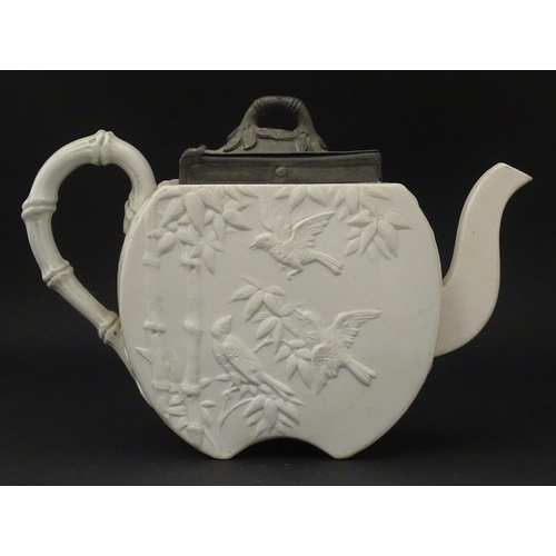 205 - A Victorian Copeland Spode bisque teapot with Aesthetic period decoration depicting birds and bamboo... 