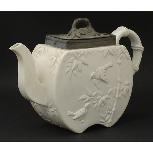 205 - A Victorian Copeland Spode bisque teapot with Aesthetic period decoration depicting birds and bamboo... 