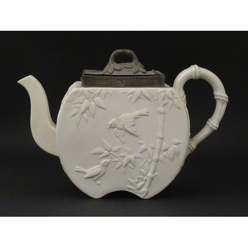 205 - A Victorian Copeland Spode bisque teapot with Aesthetic period decoration depicting birds and bamboo... 