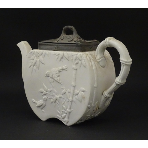 205 - A Victorian Copeland Spode bisque teapot with Aesthetic period decoration depicting birds and bamboo... 