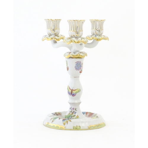 255 - A Herend porcelain two sectional three branch candlestick / candelabrum decorated in the pattern Que... 