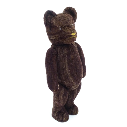 1427 - Toy: A 20thC straw filled teddy bear with stitched nose, mouth and claws, pad paws and articulated l... 