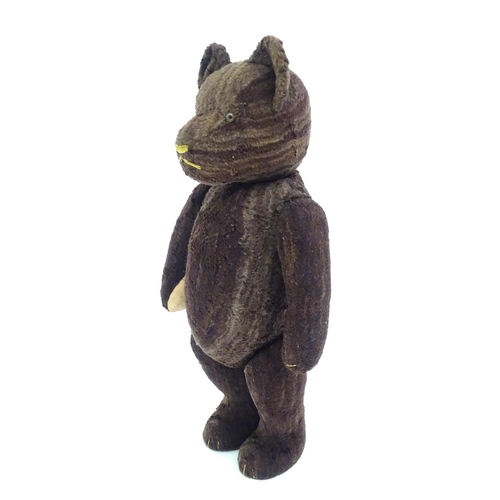 1427 - Toy: A 20thC straw filled teddy bear with stitched nose, mouth and claws, pad paws and articulated l... 