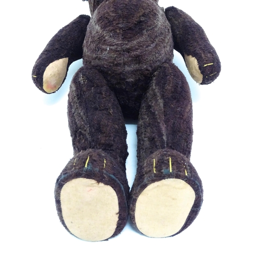 1427 - Toy: A 20thC straw filled teddy bear with stitched nose, mouth and claws, pad paws and articulated l... 