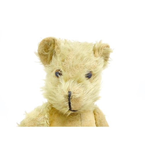 1432 - Toy: A 20thC straw filled mohair teddy bear with stitched nose and mouth, pad paws and articulated l... 