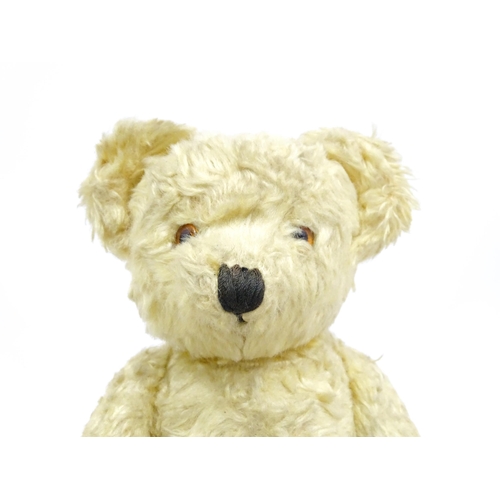 1435 - Toy: A 20thC straw filled teddy bear with stitched nose, mouth, and claws, pad paws and articulated ... 