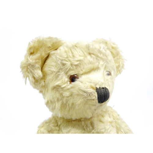 1435 - Toy: A 20thC straw filled teddy bear with stitched nose, mouth, and claws, pad paws and articulated ... 