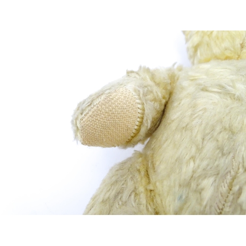 1435 - Toy: A 20thC straw filled teddy bear with stitched nose, mouth, and claws, pad paws and articulated ... 