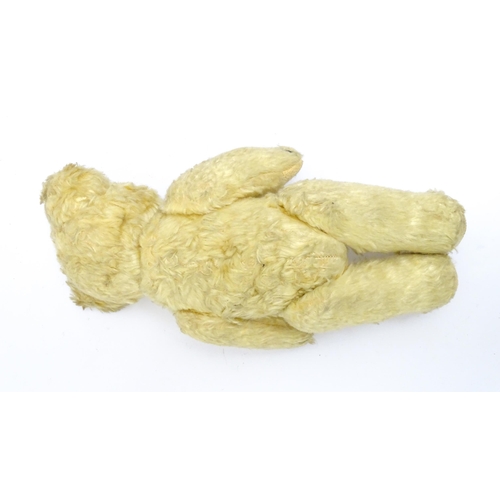 1435 - Toy: A 20thC straw filled teddy bear with stitched nose, mouth, and claws, pad paws and articulated ... 