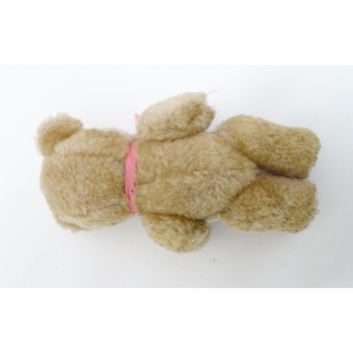 1439 - Toy: A small 20thC teddy bear with stitched nose, mouth and claws, pad paws, articulated limbs and a... 