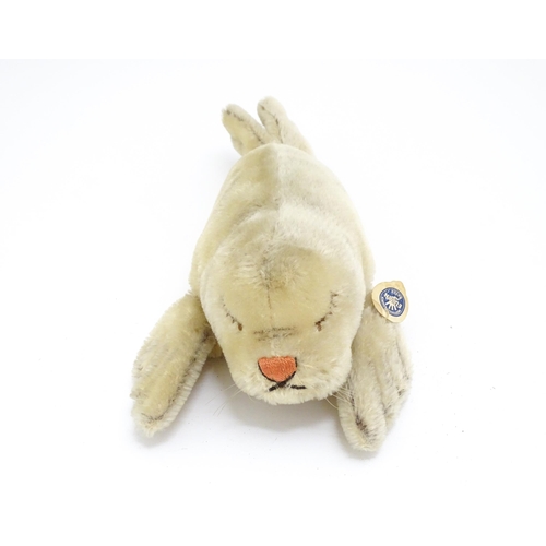 1444 - Toy: A 20thC Steiff mohair soft toy modelled as a sleeping seal - Floppy Robby, with stitched nose, ... 