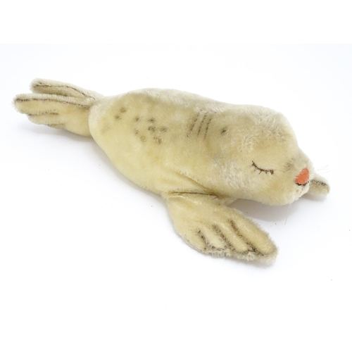 1444 - Toy: A 20thC Steiff mohair soft toy modelled as a sleeping seal - Floppy Robby, with stitched nose, ... 