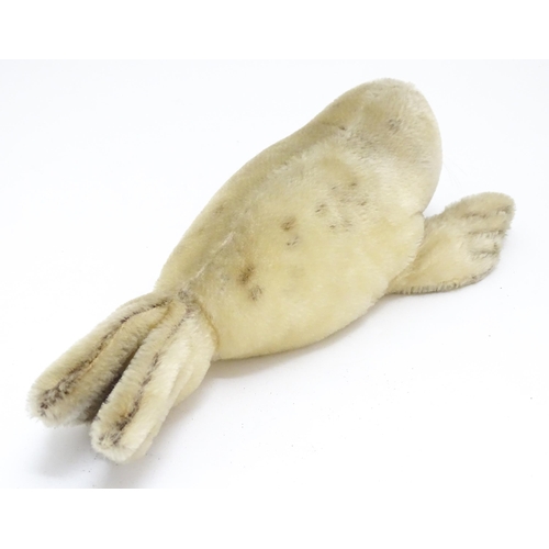 1444 - Toy: A 20thC Steiff mohair soft toy modelled as a sleeping seal - Floppy Robby, with stitched nose, ... 