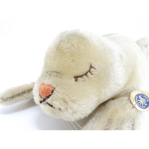 1444 - Toy: A 20thC Steiff mohair soft toy modelled as a sleeping seal - Floppy Robby, with stitched nose, ... 