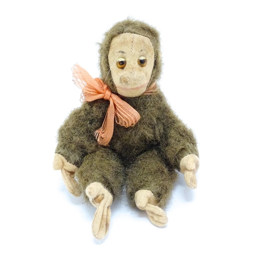 1447 - Toy: A small 20thC straw filled soft toy modelled as a monkey / chimpanzee with felt face, ears and ... 