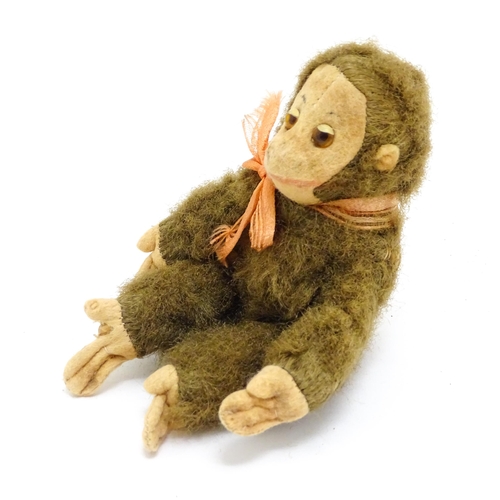 1447 - Toy: A small 20thC straw filled soft toy modelled as a monkey / chimpanzee with felt face, ears and ... 