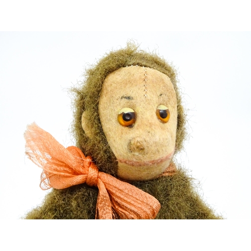 1447 - Toy: A small 20thC straw filled soft toy modelled as a monkey / chimpanzee with felt face, ears and ... 