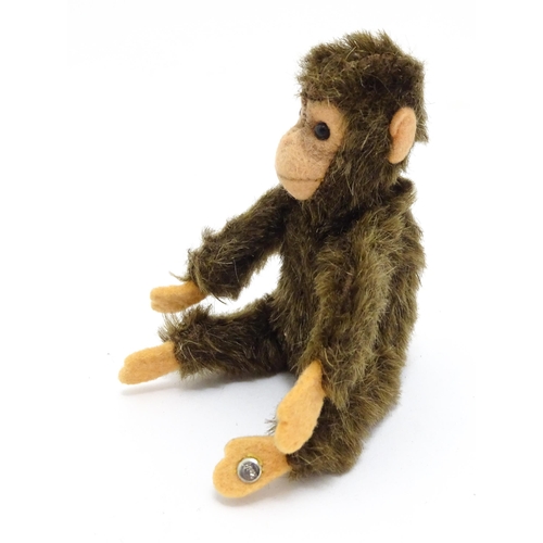 1448 - Toy: A small 20thC Steiff mohair soft toy modelled as a monkey / chimpanzee, with felt face, ears an... 