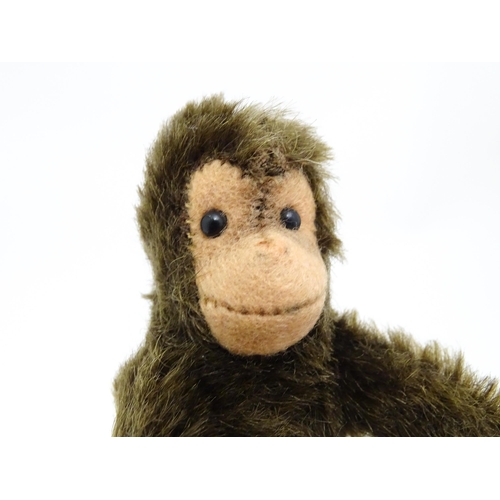 1448 - Toy: A small 20thC Steiff mohair soft toy modelled as a monkey / chimpanzee, with felt face, ears an... 