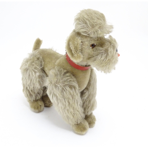 1452 - Toy: A 20thC Steiff mohair soft toy modelled as a Poodle dog - Snobby, with felt tongue, articulated... 