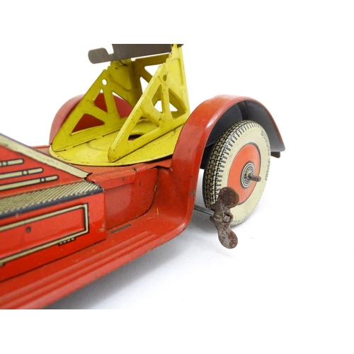 1455 - Toys: An early 20thC Mettoy tin plate clockwork fire engine with two firemen figures, a yellow ladde... 