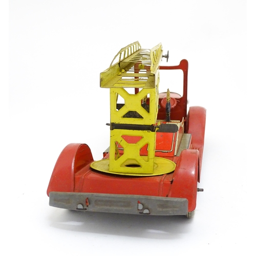 1455 - Toys: An early 20thC Mettoy tin plate clockwork fire engine with two firemen figures, a yellow ladde... 