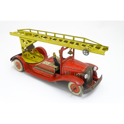 1455 - Toys: An early 20thC Mettoy tin plate clockwork fire engine with two firemen figures, a yellow ladde... 