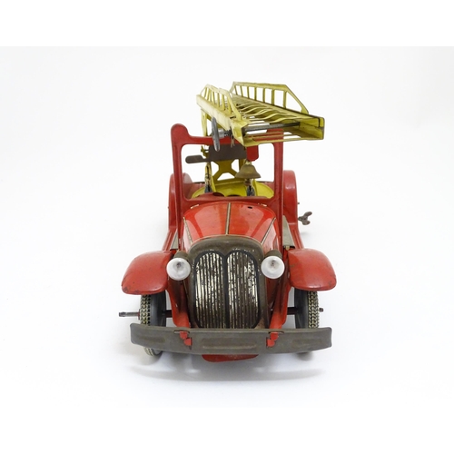 1455 - Toys: An early 20thC Mettoy tin plate clockwork fire engine with two firemen figures, a yellow ladde... 