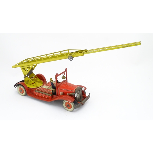 1455 - Toys: An early 20thC Mettoy tin plate clockwork fire engine with two firemen figures, a yellow ladde... 