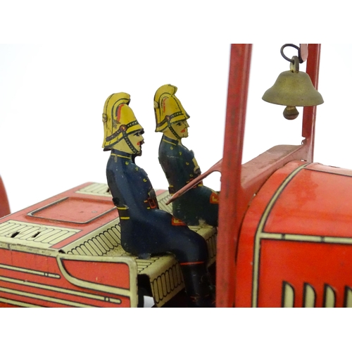 1455 - Toys: An early 20thC Mettoy tin plate clockwork fire engine with two firemen figures, a yellow ladde... 