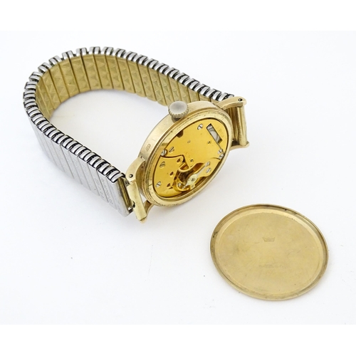 821 - A 9ct gold cased Smiths wristwatch, the dial signed ' Smiths De Luxe 15 jewels Shockproof , with sec... 