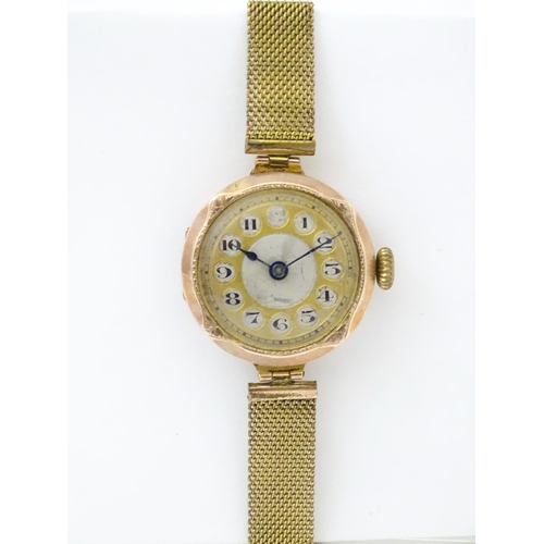 822 - A 9ct gold cased ladies wristwatch with rolled gold watch strap. Dial approx 7/8