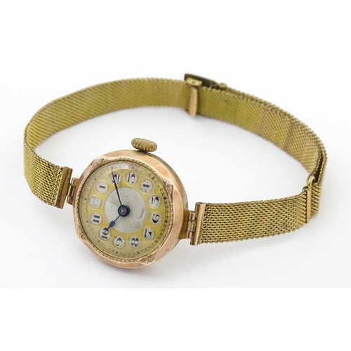 822 - A 9ct gold cased ladies wristwatch with rolled gold watch strap. Dial approx 7/8