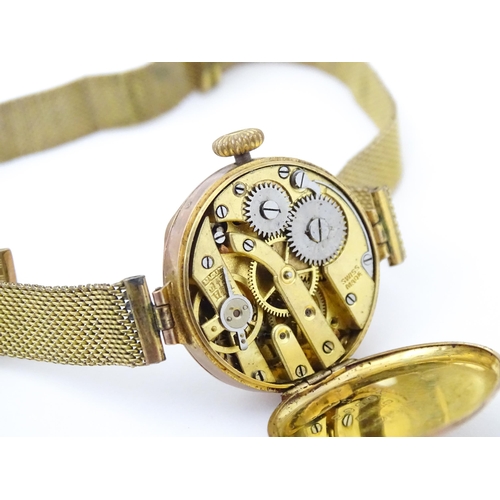 822 - A 9ct gold cased ladies wristwatch with rolled gold watch strap. Dial approx 7/8