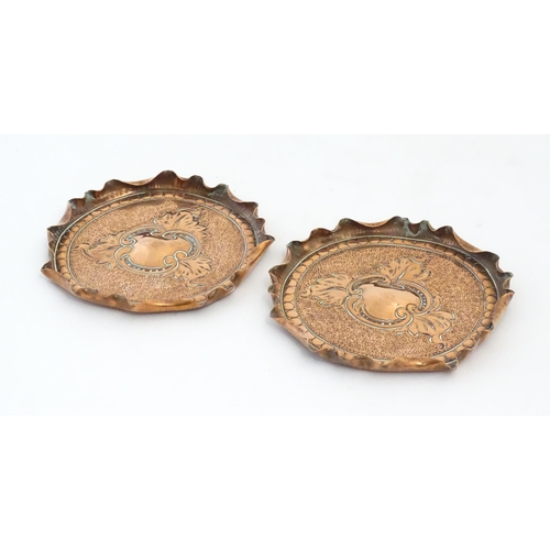 1089 - Two early 20thC copper dishes with embossed foliate decoration, punchwork detail and fluted rims. Ap... 