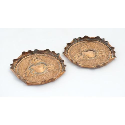 1089 - Two early 20thC copper dishes with embossed foliate decoration, punchwork detail and fluted rims. Ap... 