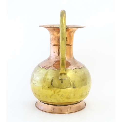 1093 - A large 20thC Belgian brass and copper vase / urn with twin loop handles. Marked under. Approx. 15