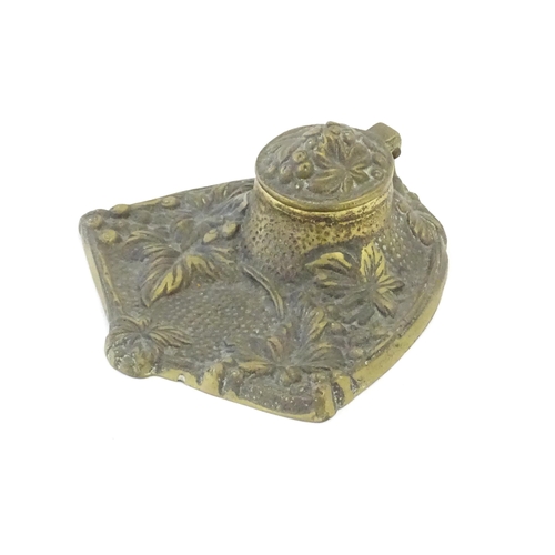 1096 - An early 20thC cast brass inkwell decorated with foliage and berries. Approx. 5