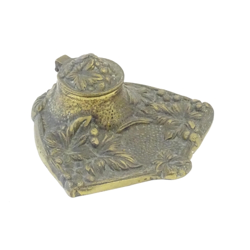 1096 - An early 20thC cast brass inkwell decorated with foliage and berries. Approx. 5