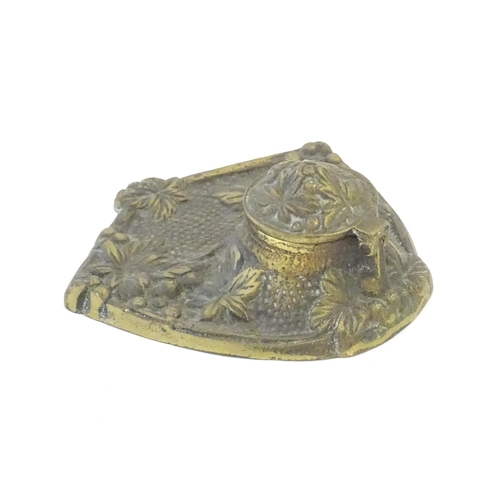 1096 - An early 20thC cast brass inkwell decorated with foliage and berries. Approx. 5