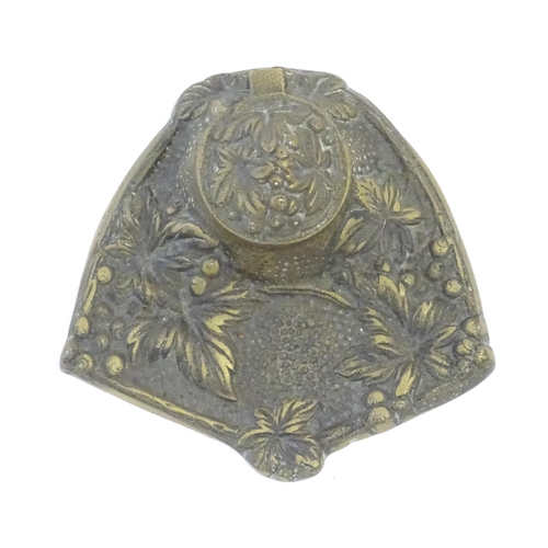 1096 - An early 20thC cast brass inkwell decorated with foliage and berries. Approx. 5